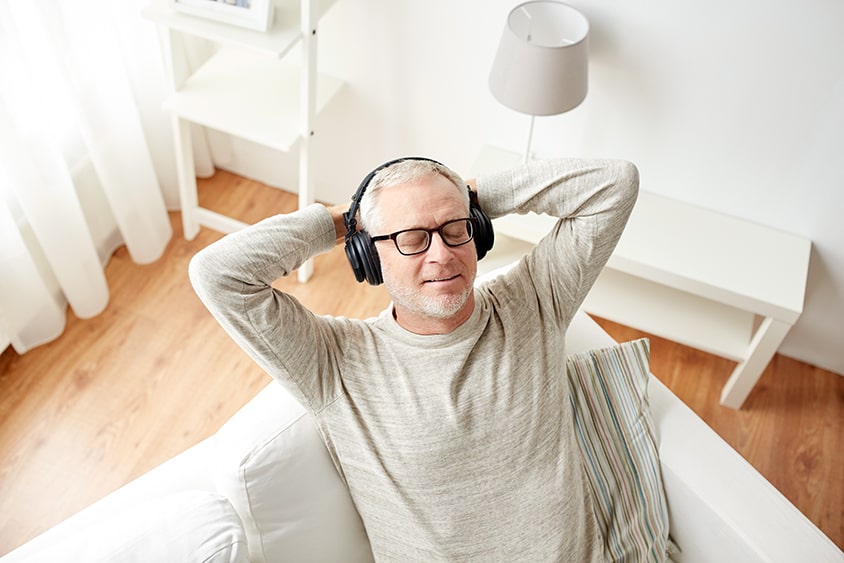 Man resting with his eyes closed while listening to his NuCalm device for his consultation with Dr. Pamela Marzban